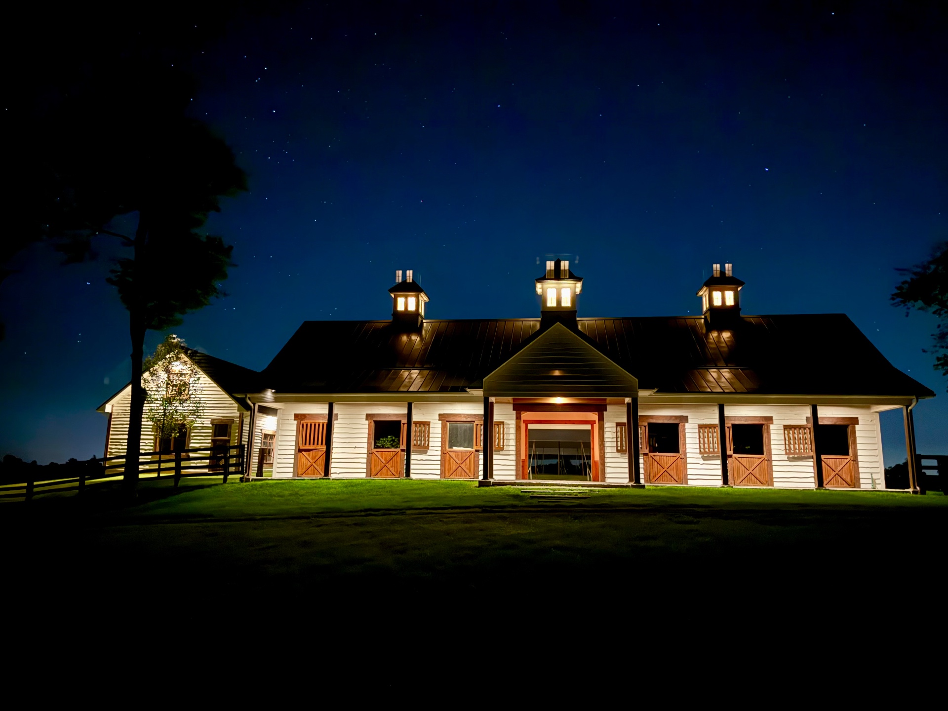 Heritage stables at Augustus Hill Farm beneath a Kentucky sky