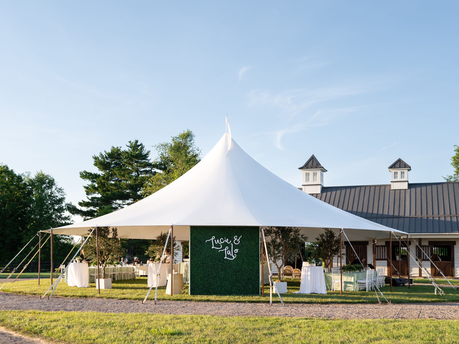Cocktail lawn with sailcloth tent overlooking the stables at Augustus Hill
